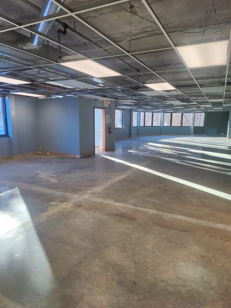 Finished commercial flooring removal project showing clean concrete floor